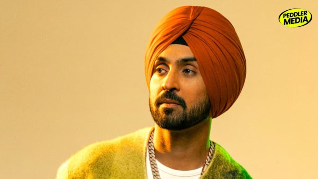Diljit Dosanjh wearing an orange turban close up HD Photo