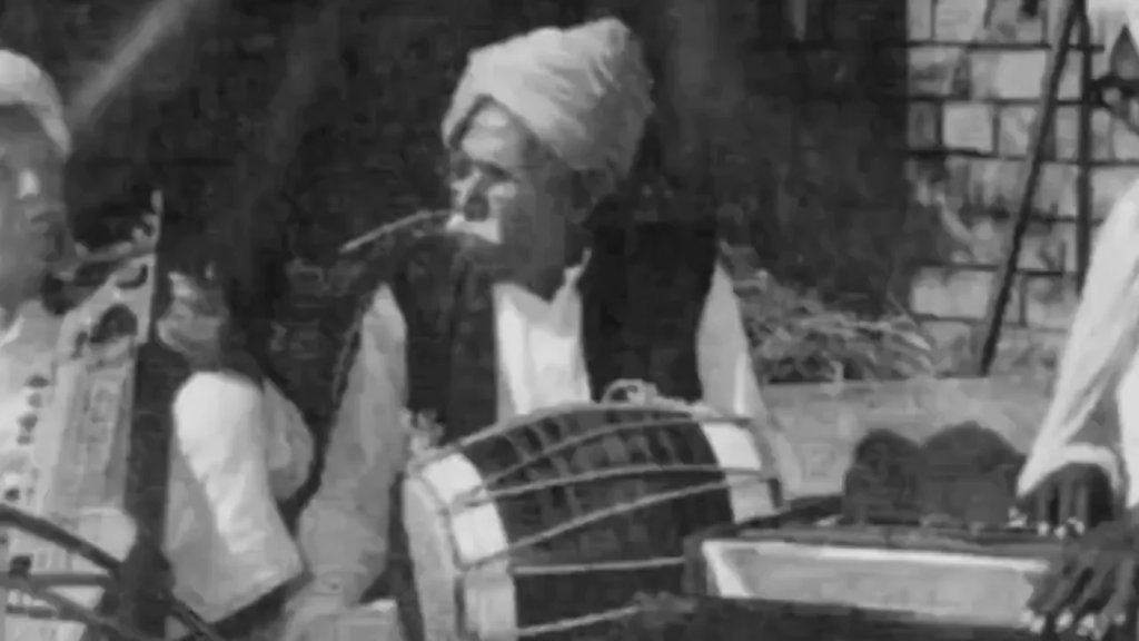 Traditional Haryanvi folk musicians Lakhmi Chand performing with dholak and instruments in rural setting