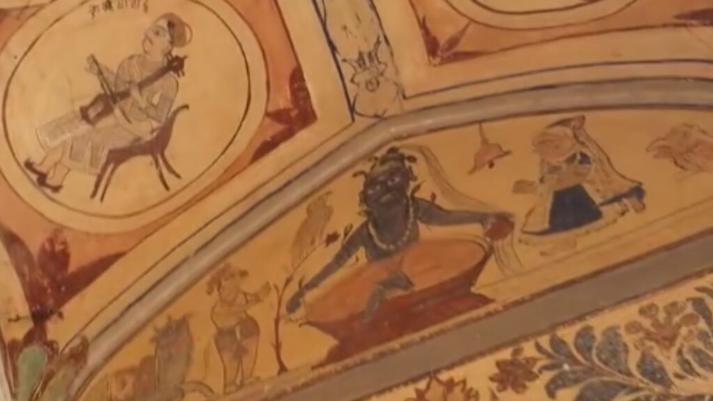 Ancient wall paintings inside a Haryana Chaupal showing traditional musicians and figures