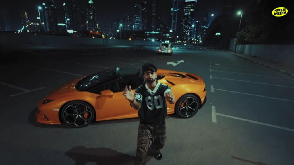 Billa Sonipat Ala wearing NFL jersey and camo cargo pants in KIDS music video