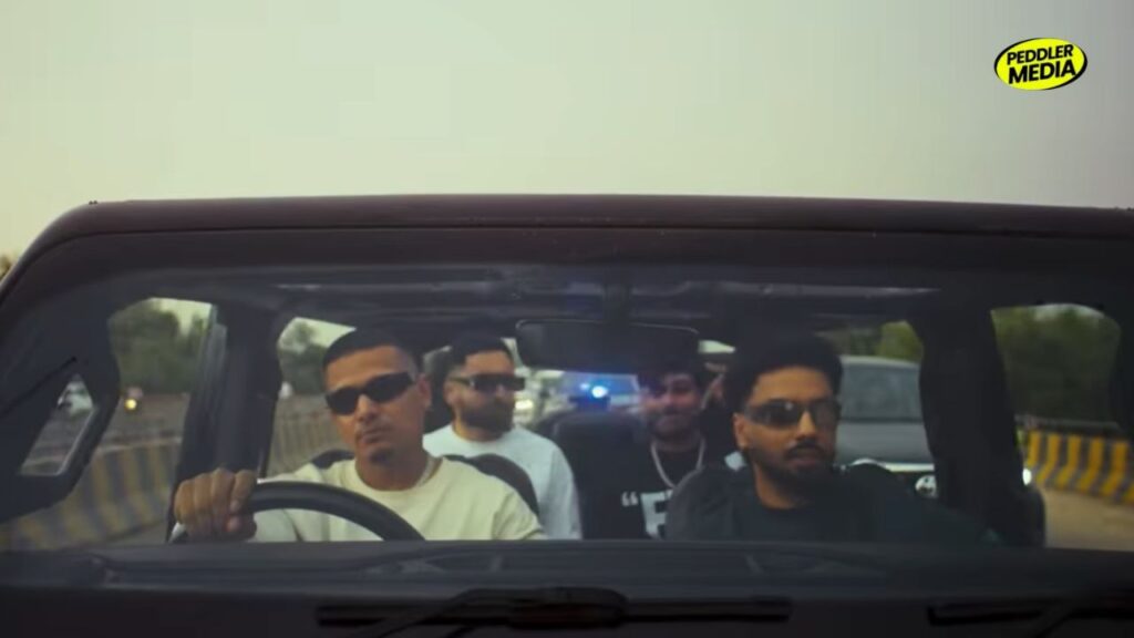 Dhanda Nyoliwala and crew driving in a jeep in the Kath Lagda music video