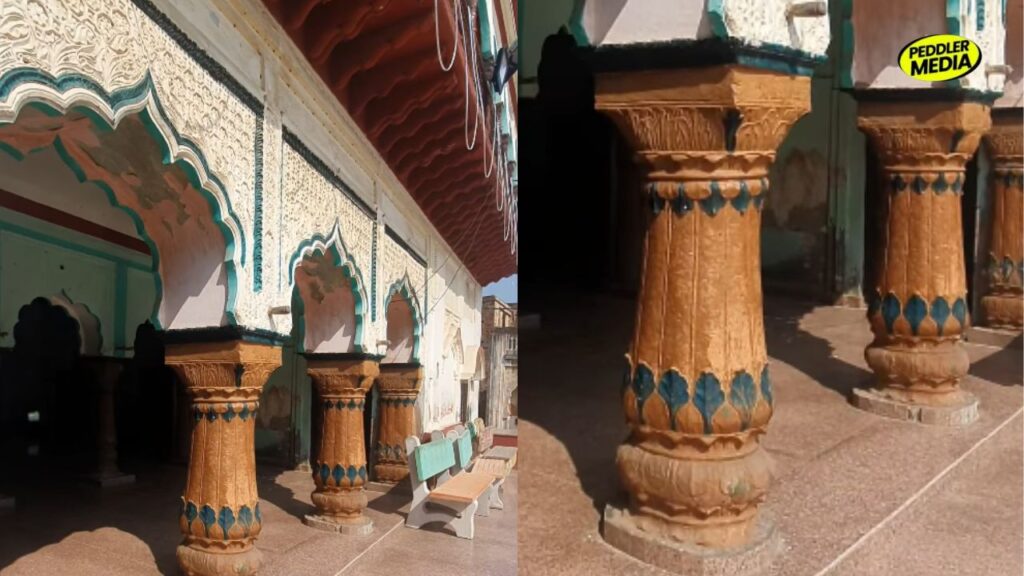 Hand-carved stone pillars and decorated arches inside a traditional Haryana Chaupal