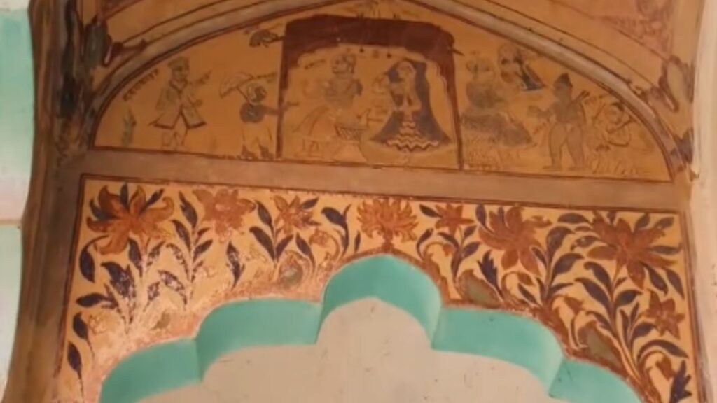 raditional folk art frescoes with floral patterns and human figures painted inside a Haryana village Chaupal