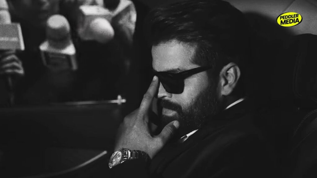 Black and white close-up of Masoom Sharma in sunglasses inside a car
