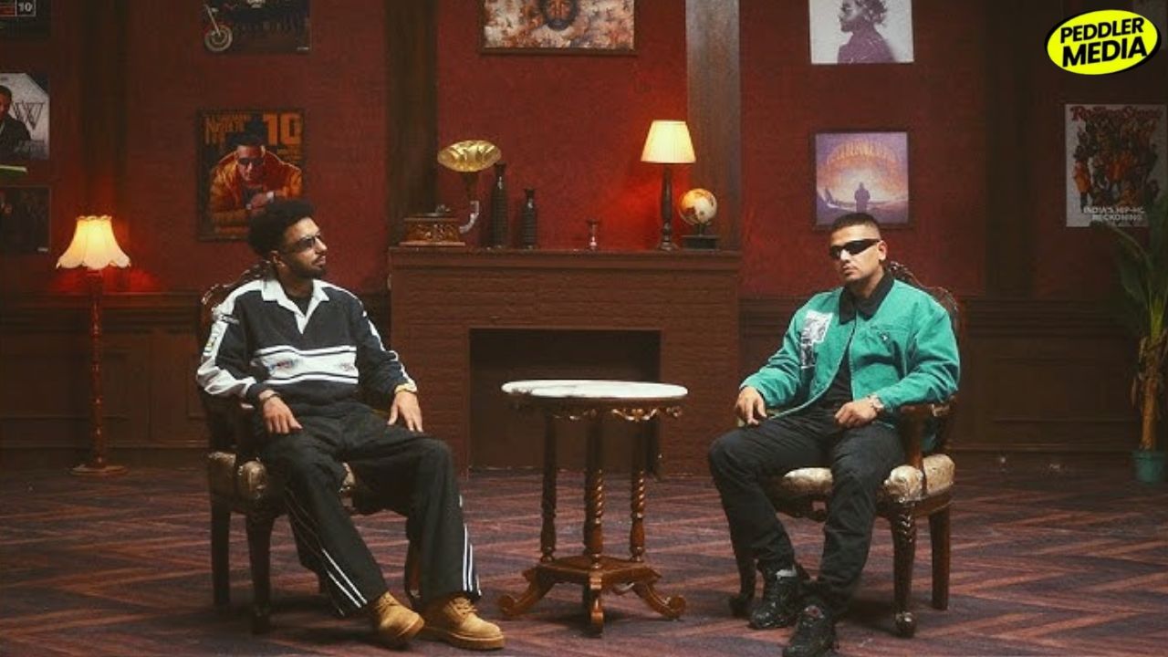 Navaan Sandhu and Dhanda Nyoliwala sitting together in the Kath Lagda music video