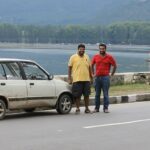 Two boys from Punjab standing next to their 1997 Maruti 800 PB 43 7700 at Dal Lake Srinagar during Leh road trip