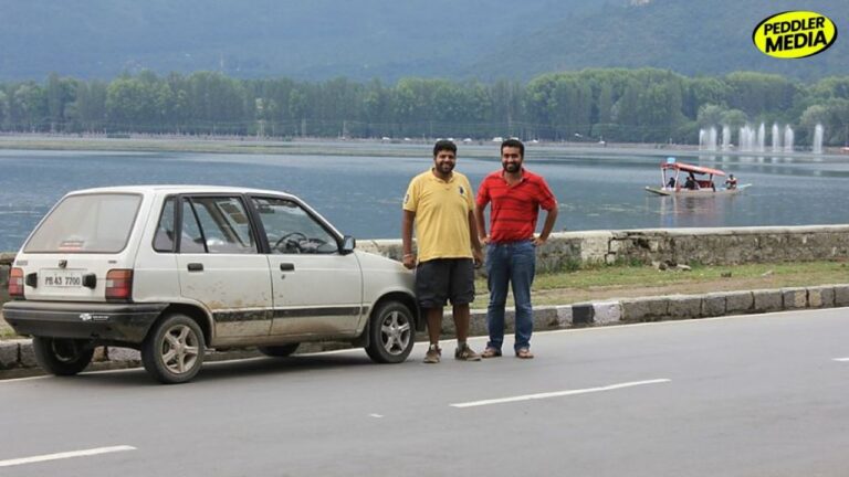 Two boys from Punjab standing next to their 1997 Maruti 800 PB 43 7700 at Dal Lake Srinagar during Leh road trip