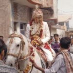 Haryanvi Wedding Rituals groom riding a decorated horse during Ghudchadi wedding procession