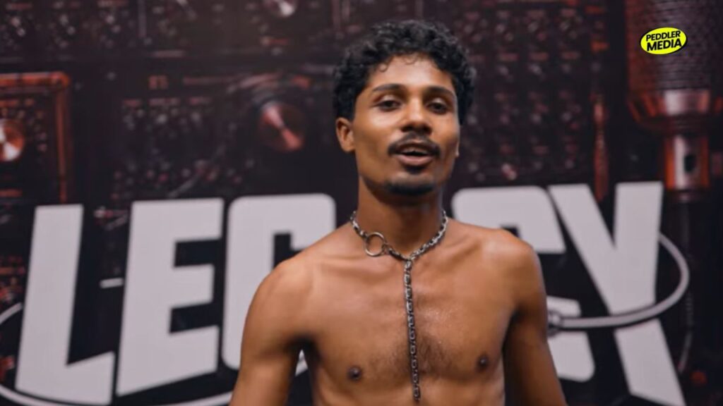 Hussain performs during Legacy Episode 4 rap competition, showcasing his energetic stage presence in India's hip-hop reality show.