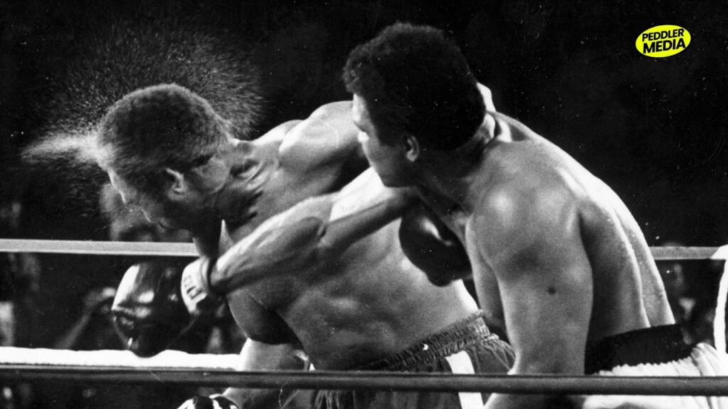 Muhammad Ali landing a hard punch on Joe Frazier during the Thrilla in Manila boxing match.