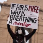 youth protest delhi placard protester at India Gate