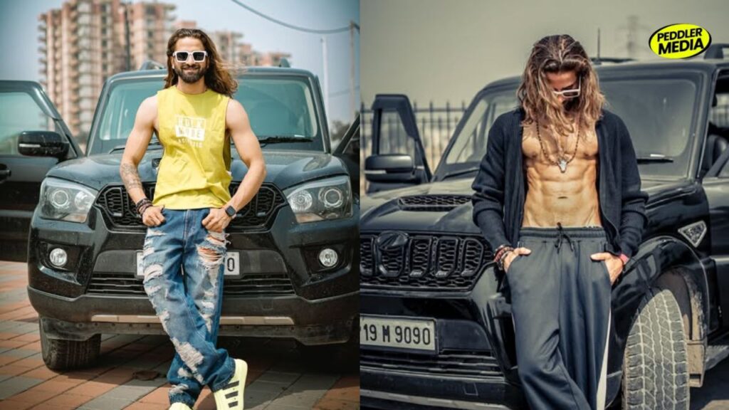 Ankit Baliyan posing in front of his car