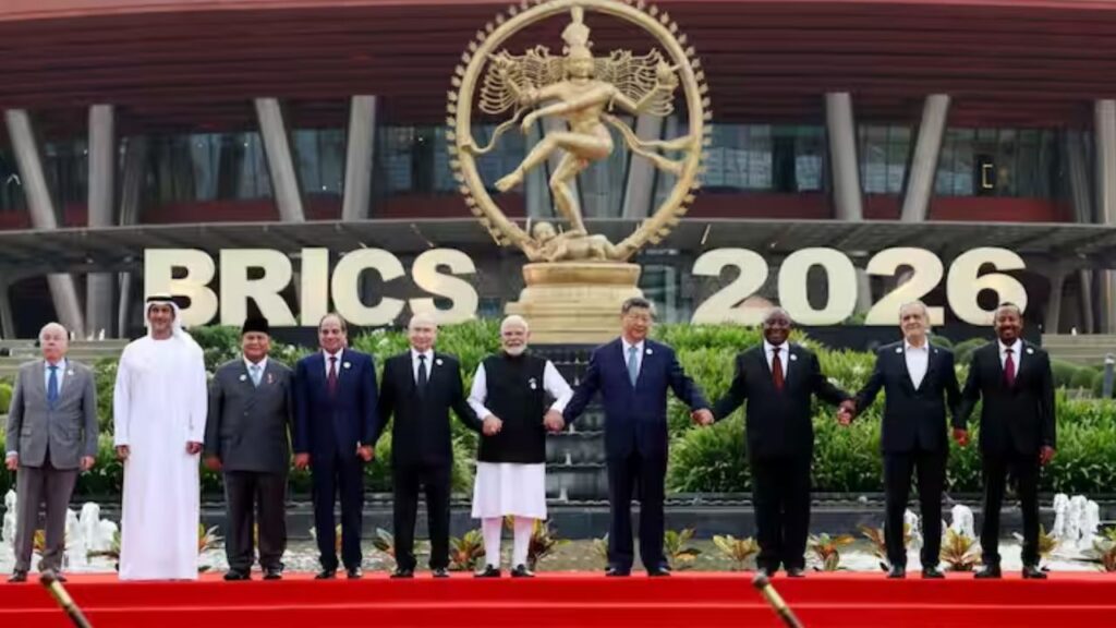 PM Narendra Modi holding hands with world leaders including Xi Jinping and Vladimir Putin at the BRICS Summit 2026 at Bharat Mandapam, New Delhi.