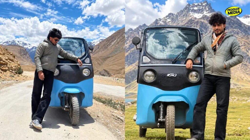 Sumit Prajapati posing next to his blue electric vehicle during his viral e-rickshaw to Spiti Valley mountain trip