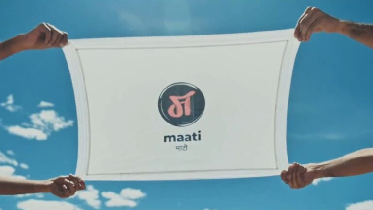 Maati Season 2 logo held up against a blue sky, Warner Music India folk label