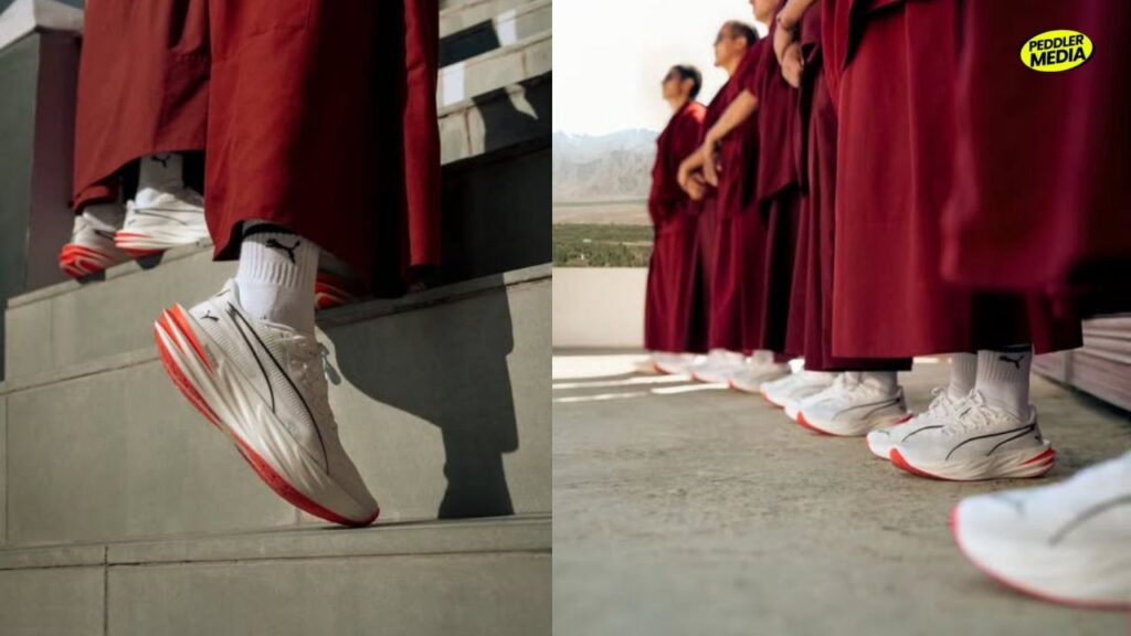 Close-up of PUMA Deviate PURE NITRO white and red sneakers worn by Buddhist monks in maroon robes, Ladakh monastery