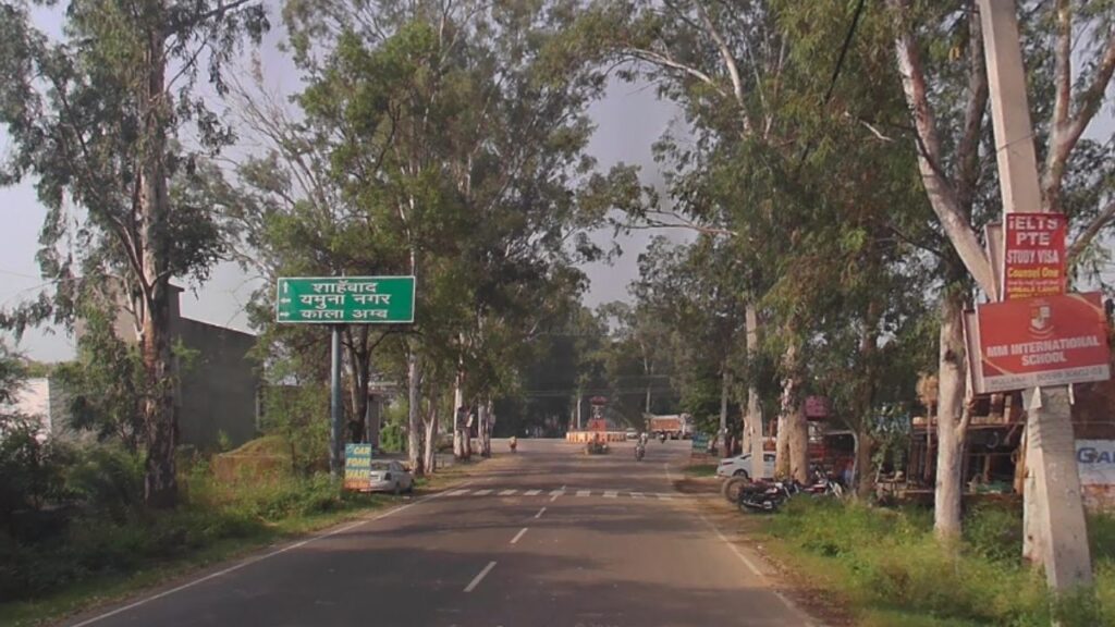 A state highway SH-4 route signboard to explore Haryana showing directions toward Shahbad, Yamunanagar, and Kala Amb.