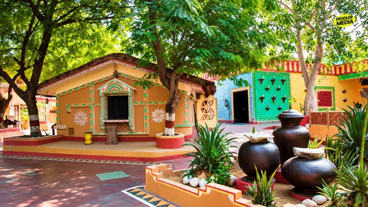 A colourful traditional village courtyard showing mud houses and clay pots representing the heritage style of Mhari Mati Agro Tourism Hisar.