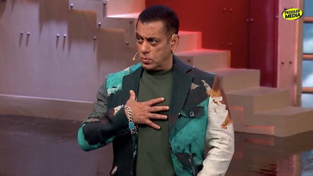 Salman Khan hosting the Bigg Boss show while wearing a green jacket.