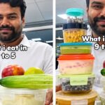 Corporate employee holding multiple tiffins at his desk for the what i eat at my 9-5 job viral internet trend.